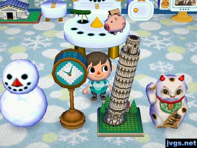 Me standing near the Pave clock and Tower of Pisa in my snowman-themed room.