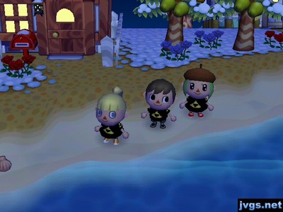 Olivia, Jeff, and Yann all wearing Triforce shirts by the beach.