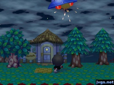 Shooting a UFO with my slingshot on a cloudy night in Animal Crossing: City Folk.