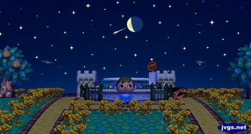 A shooting star flies past the moon in Animal Crossing: City Folk.