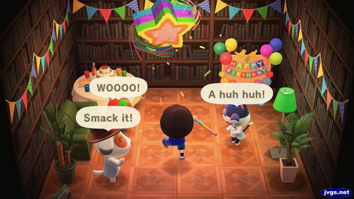 My villagers cheer me on as I smack a birthday pinata in ACNH.