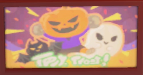 A pumpkin, ghost, and bat appear on a seasonal Halloween promotion on TV.