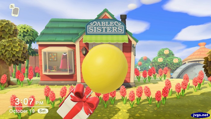 A balloon present flies by, in front of Able Sisters.