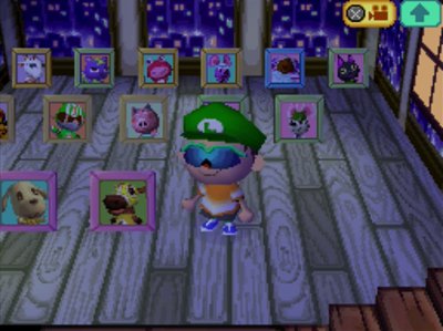 Jeff stands next to Victoria's pic in a room full of villager pictures.