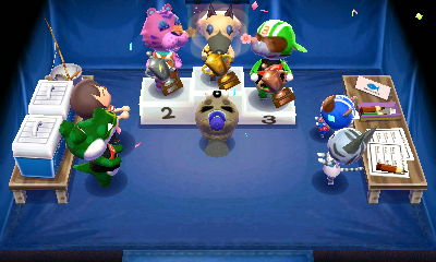 The fishing tournament winners' ceremony, with Vivian, Claudia, and Big Top up on the podium. Chip hands out trophies to the winners.